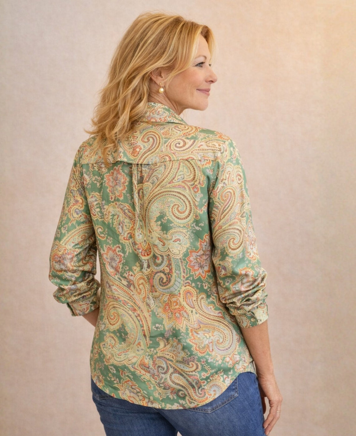 Back view of Lotus Silk Shirt in green paisley satin silk showing single pleat and longer curved hem