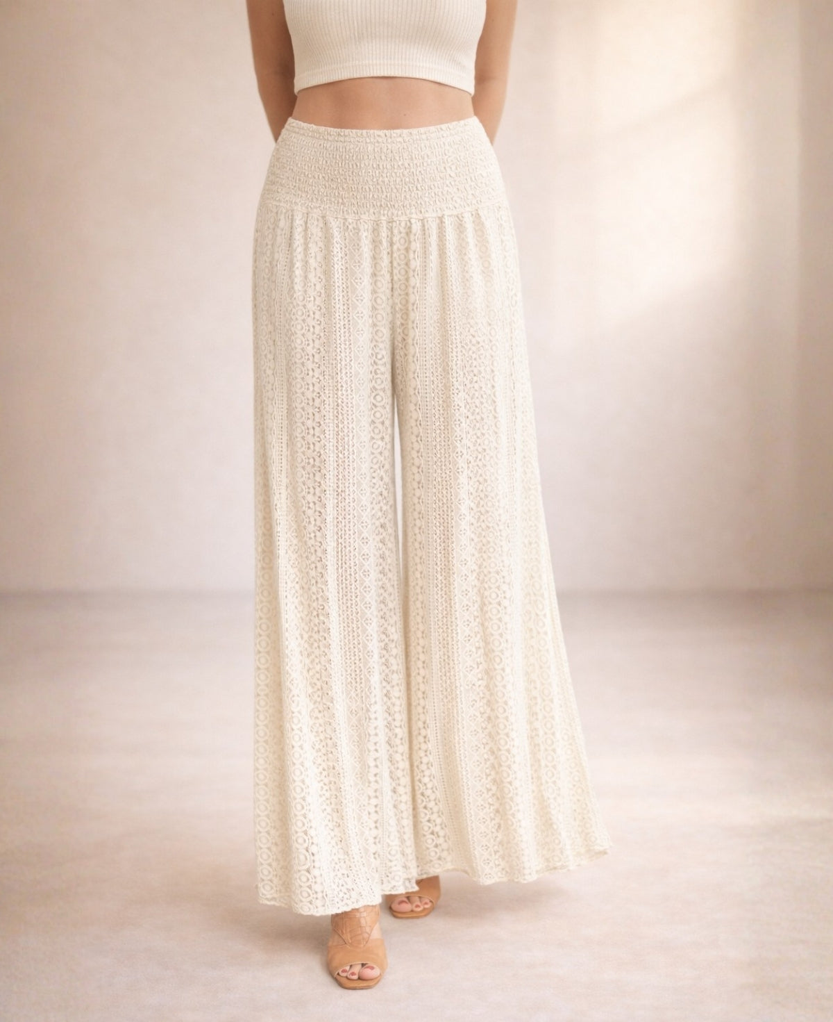 Close-up of Louella Boho Lace Pants in Beige highlighting shirred waist and flowing lace wide-leg silhouette.