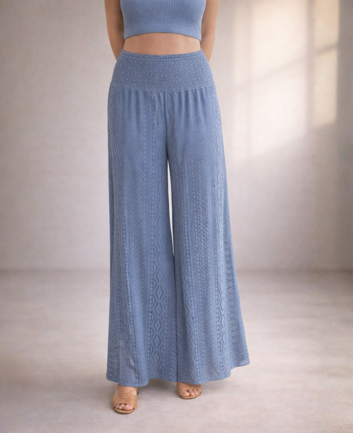 Waist-down detail of Louella Boho Lace Pants in Jeans blue featuring shirred waistband and wide-leg lace design.