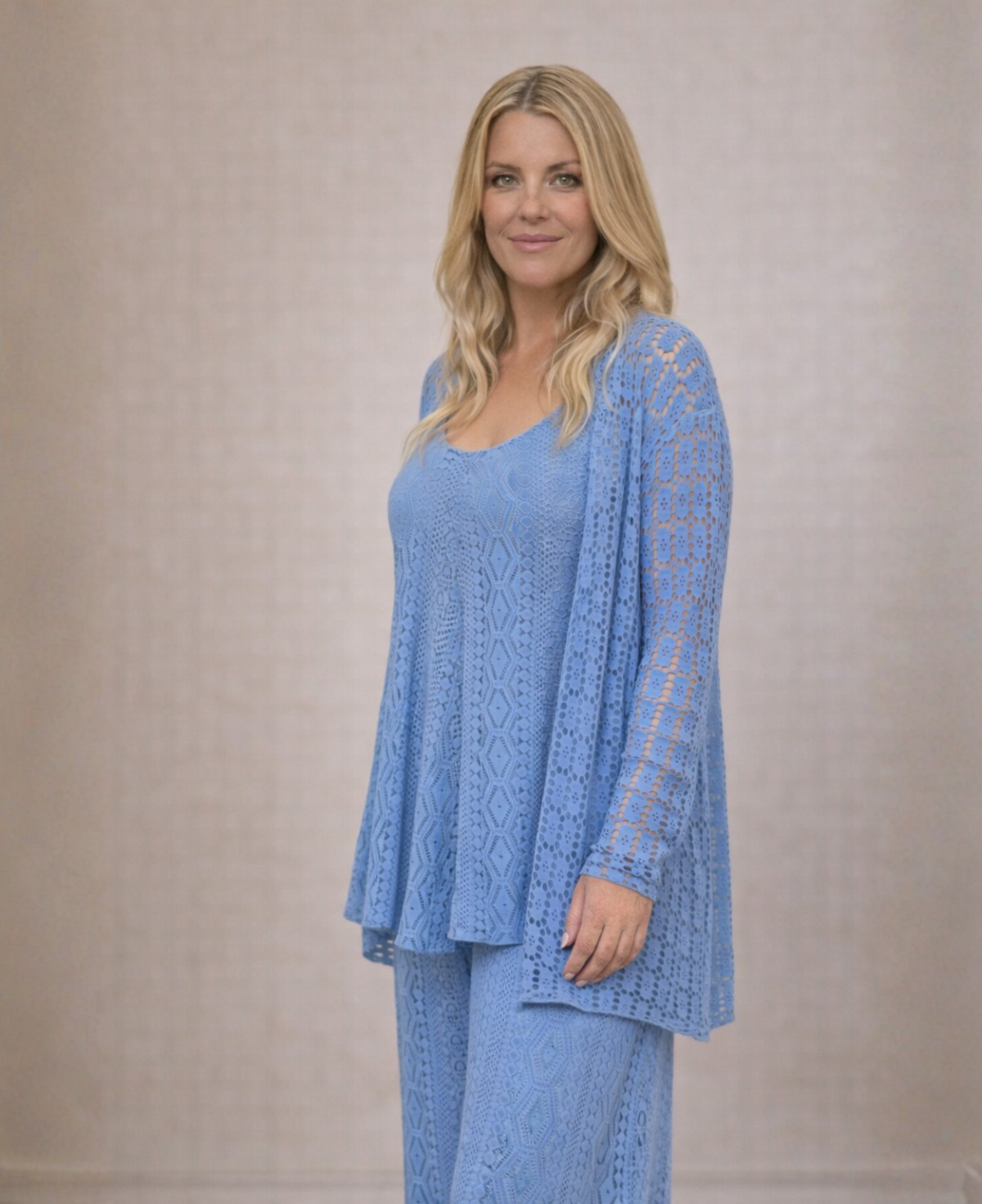 Three quarter studio image of Louella Lace Cardi in Jeans blue showing lace texture and longer open front shape.