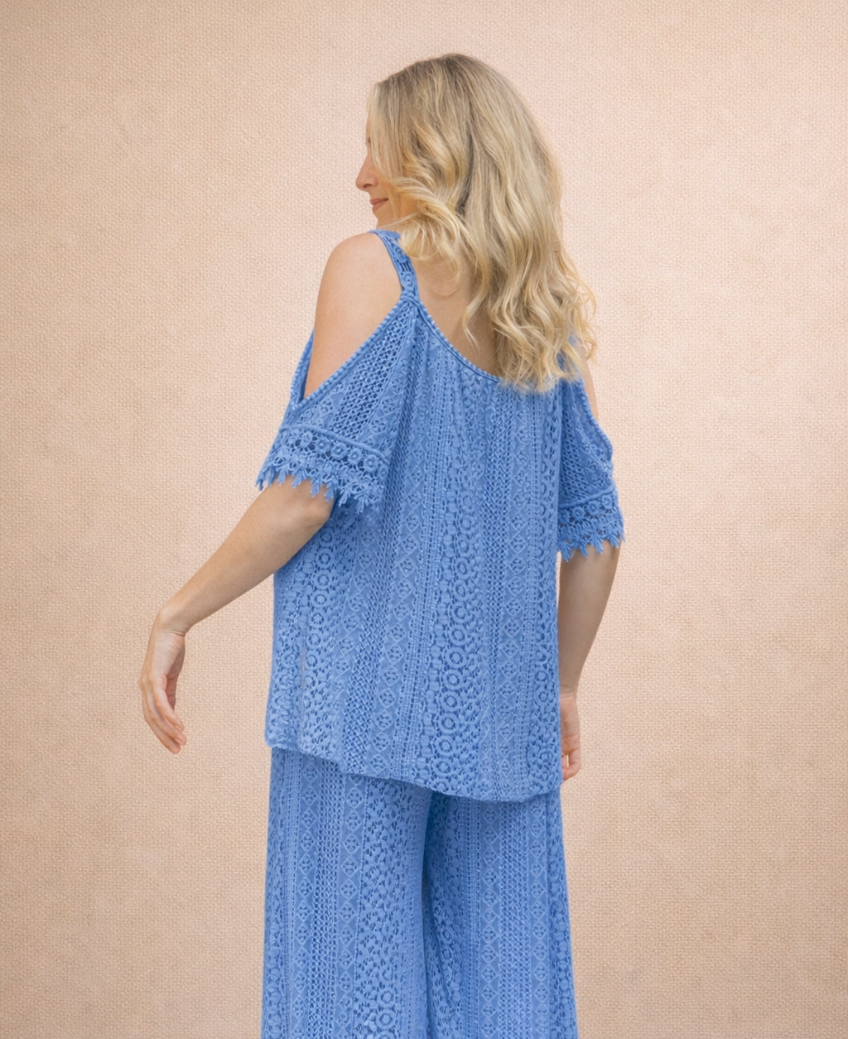 Louella Lace Cup Top in jeans blue cotton lace shown in 3/4 back angled view, dusty blue summer lace top with matching pants.