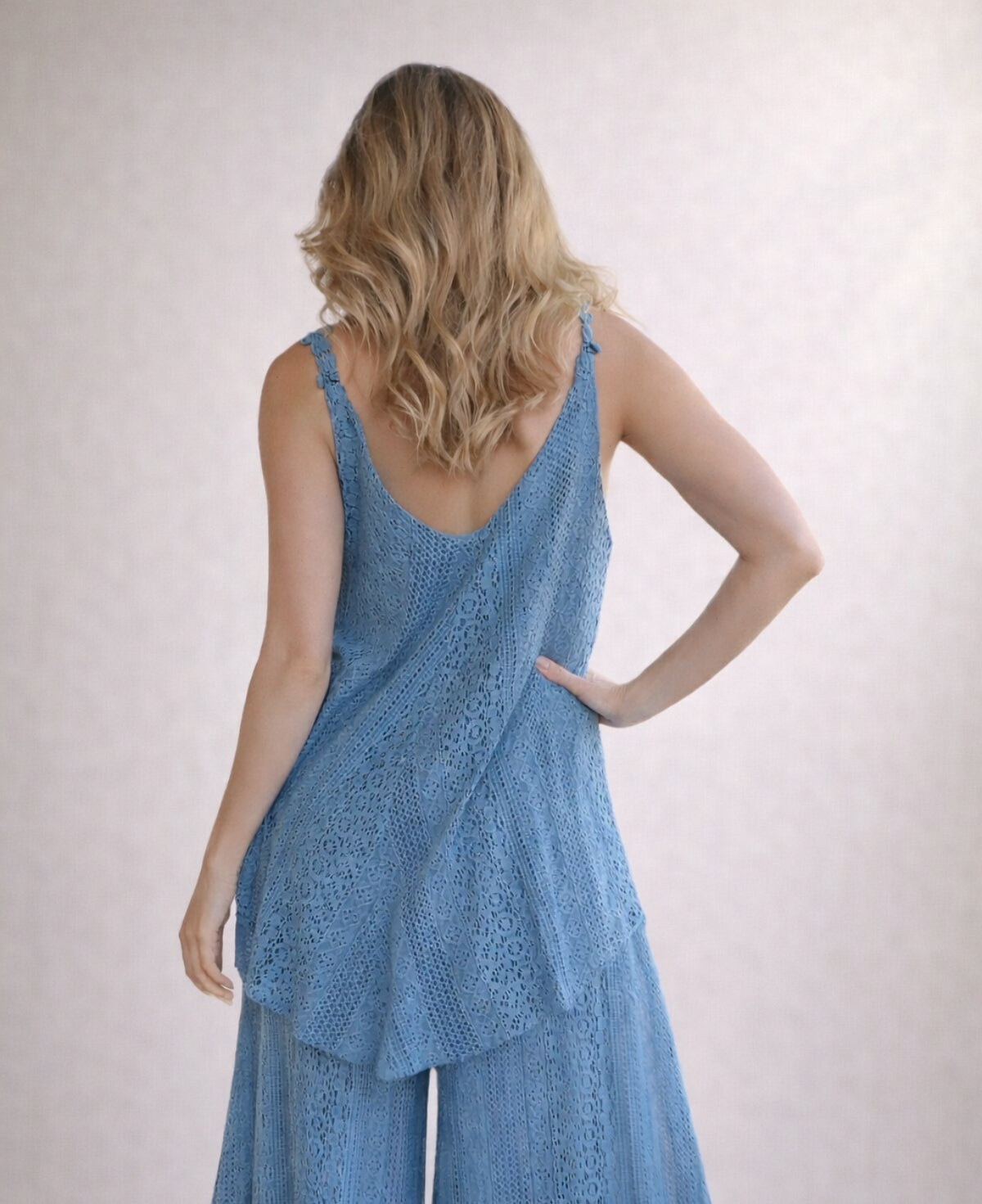 Back view of Louella lace swing top and matching pants in Jeans blue showing scalloped straps and layered hem detail.