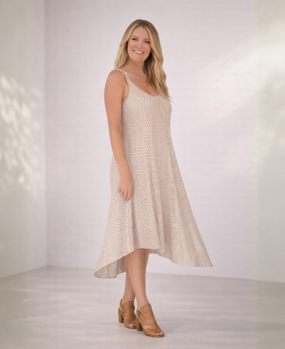 Front view of Louella Swing Lace Dress in Beige lace with relaxed fit and asymmetrical hem.