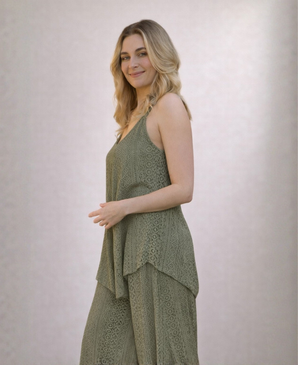 Side view of Louella lace swing top and wide leg pants in Khaki green with flowing layered silhouette in studio.