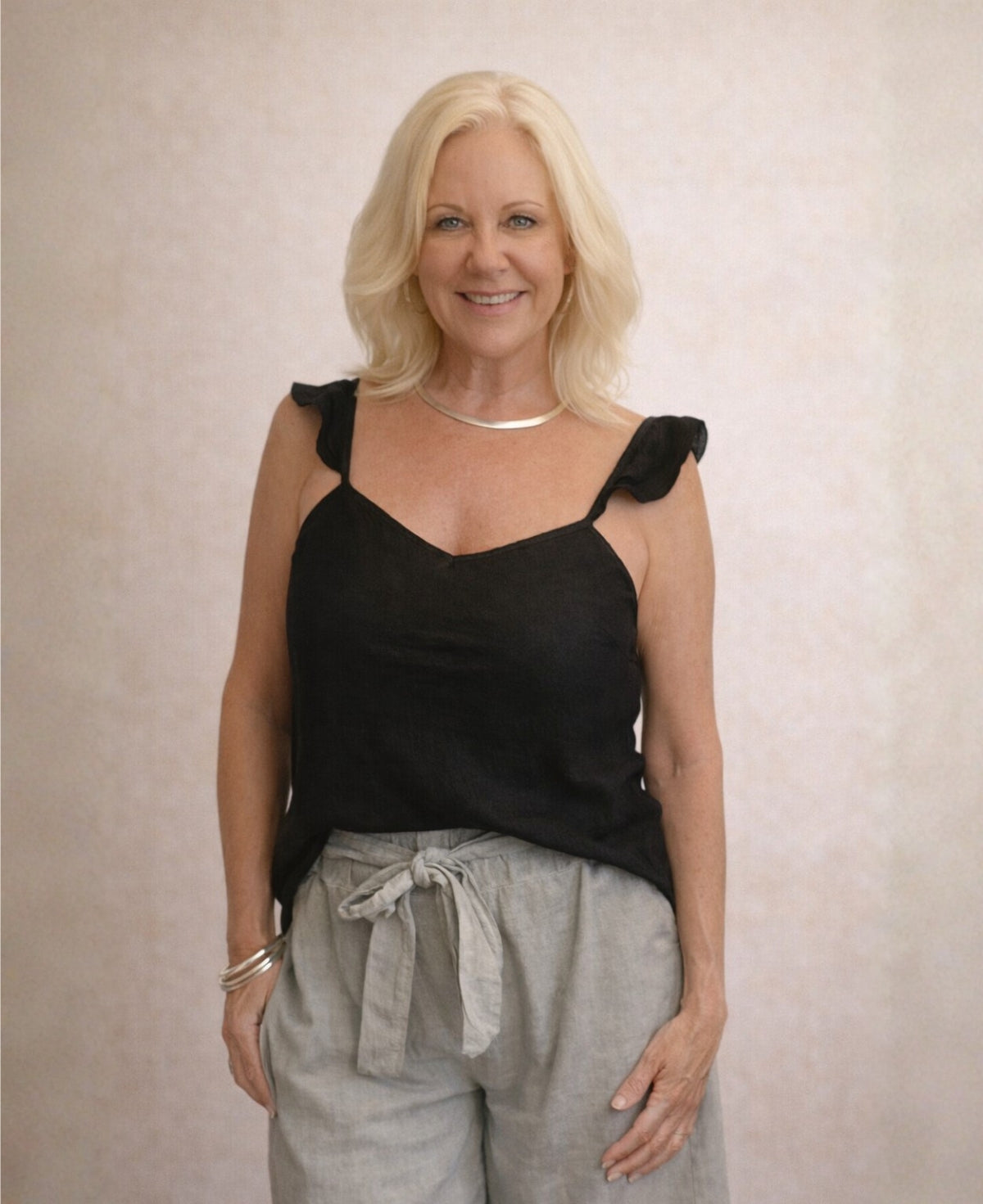 Front view of the Lydia Linen Top in black featuring the soft ruffle straps and flattering relaxed linen fit.