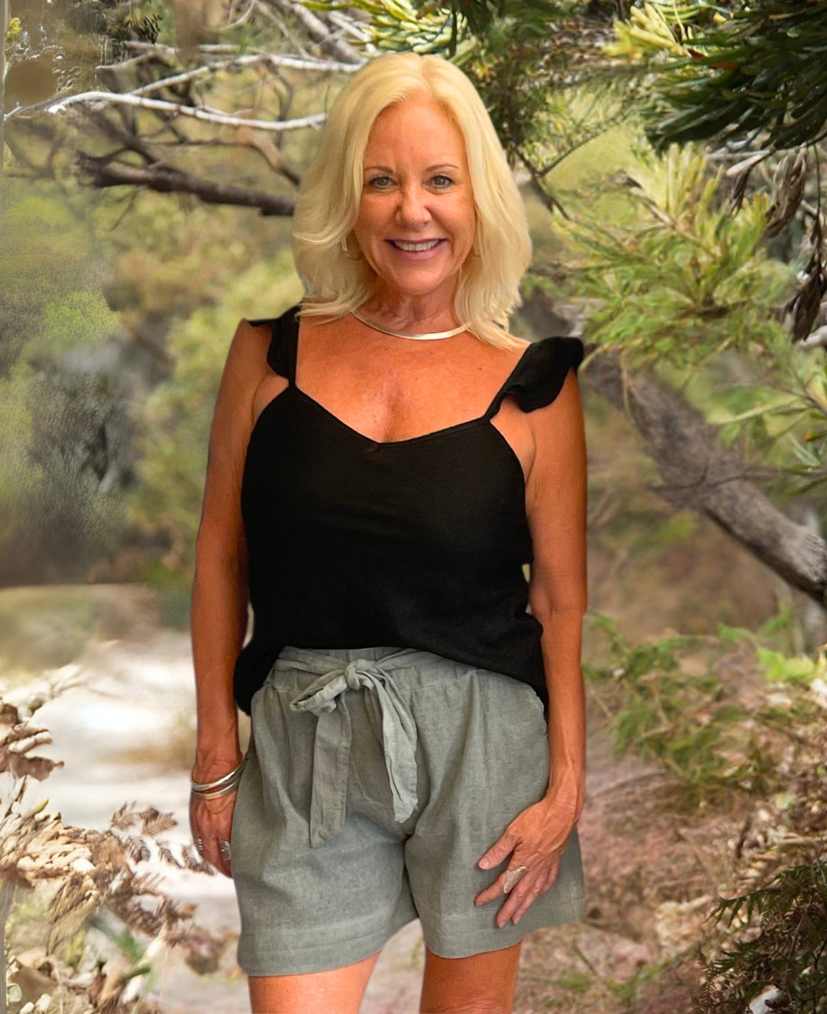 Classic black linen cami with delicate ruffle straps, bias-cut design, and premium linen fabric. A versatile and stylish staple.