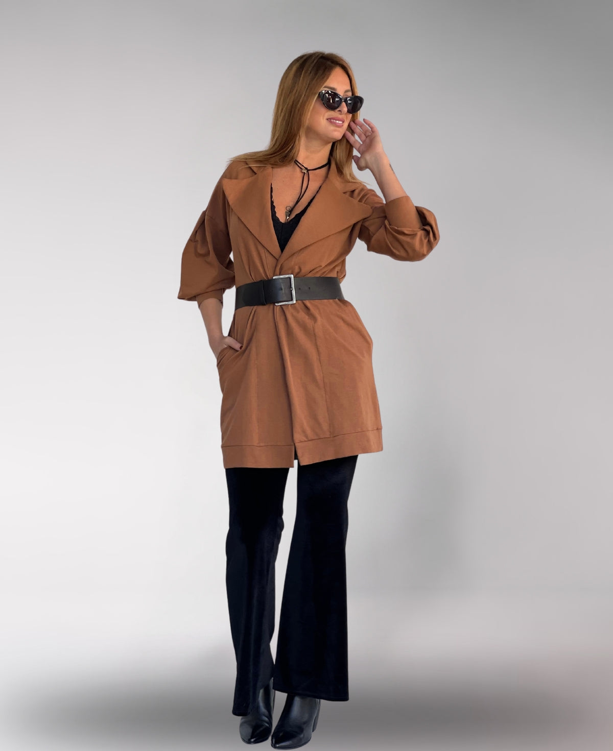 Elegant camel belted coat with a flowing hem and practical side pockets.
