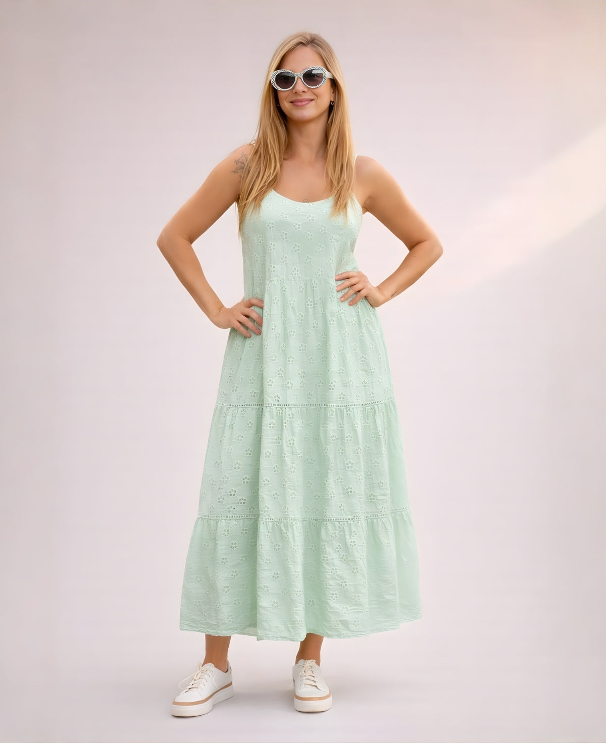 Close view of mint cotton eyelet embroidery and tiered skirt on sleeveless summer dress