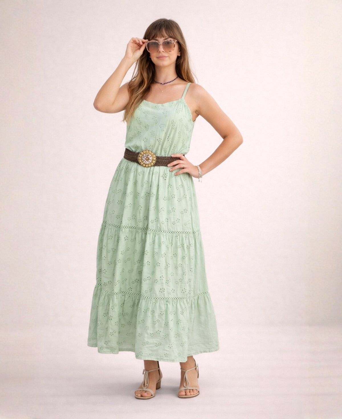 Mint green cotton eyelet maxi dress styled casually with sandals, belt and sunglasses in studio lighting