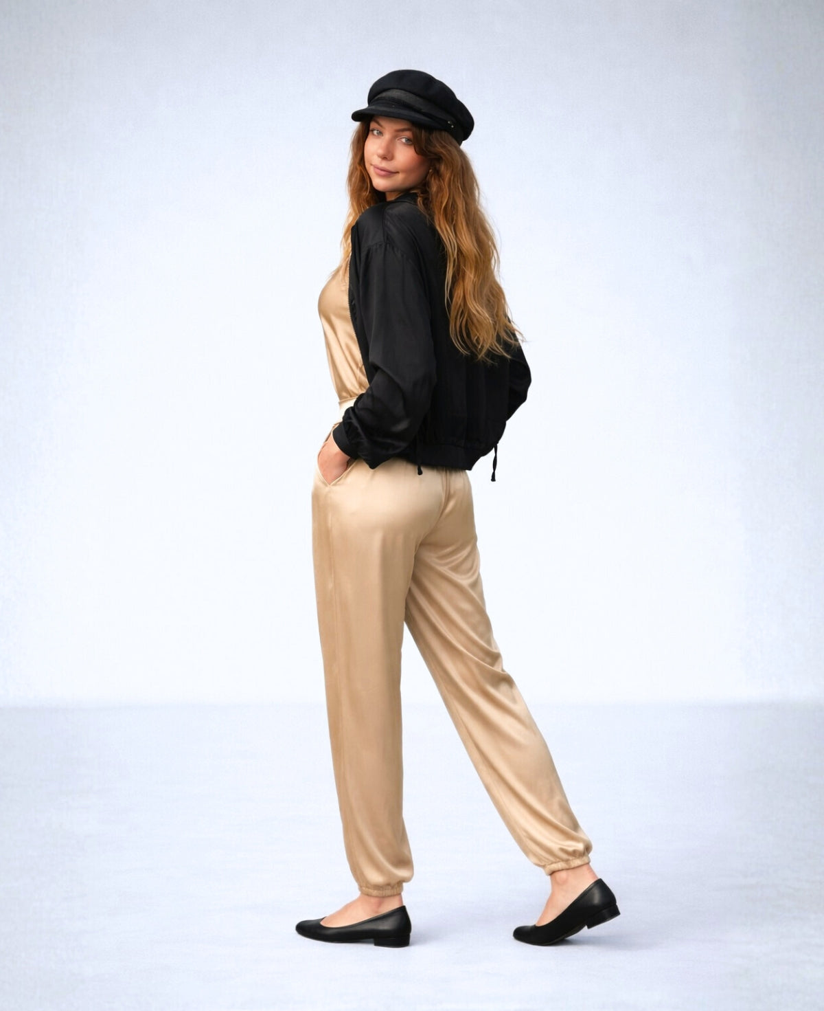 Back view of the Moulin Satin Joggers in Gold, showing the relaxed satin fit, elastic back waistband, gathered ankle cuffs, and soft drape through the legs.
