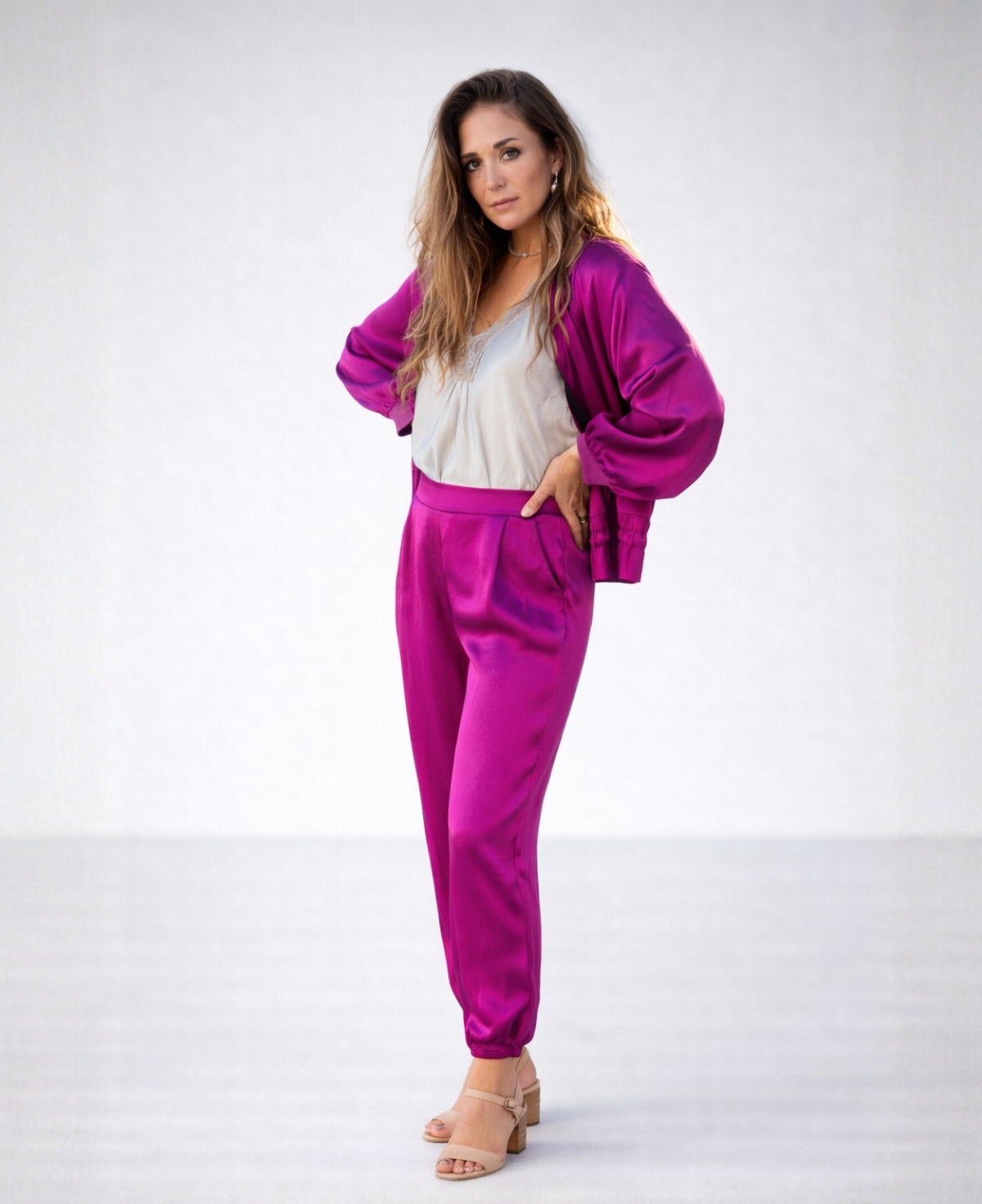 Front view of the Moulin Satin Joggers in Sangria, featuring the smooth front waist, relaxed satin fit, side pockets, and gathered ankle cuffs.