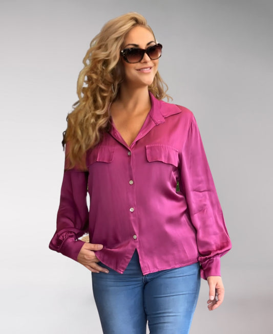 Rich Fuchsia satin button-up shirt with a collared neckline, front flap pockets, and long sleeves with buttoned cuffs. A refined and sophisticated wardrobe essential.