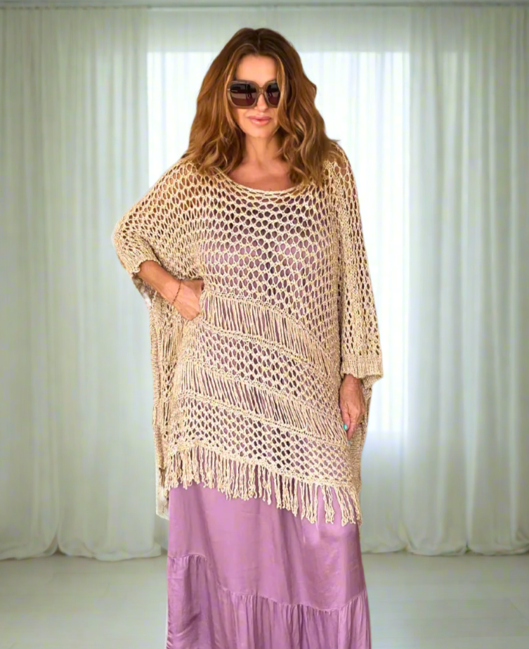 Mauve silk satin maxi dress with spaghetti straps, gathered neckline, and a ruffled asymmetrical hem, worn by a model showcasing its relaxed one-size fit