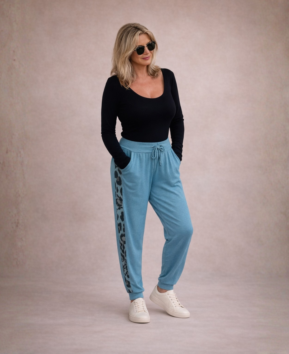 Model styling Paris Knit Jogger pants in teal with black top and sneakers casual everyday outfit