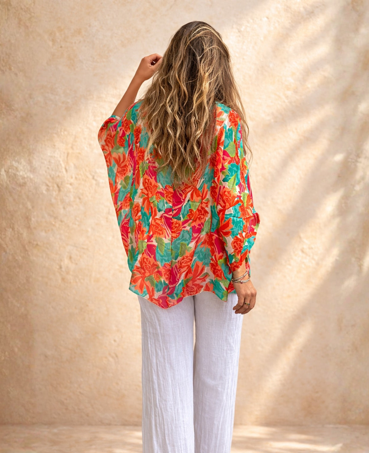 Back view of the Roses Silk Top in rose floral print showing the loose flowing silhouette and batwing sleeve shape.