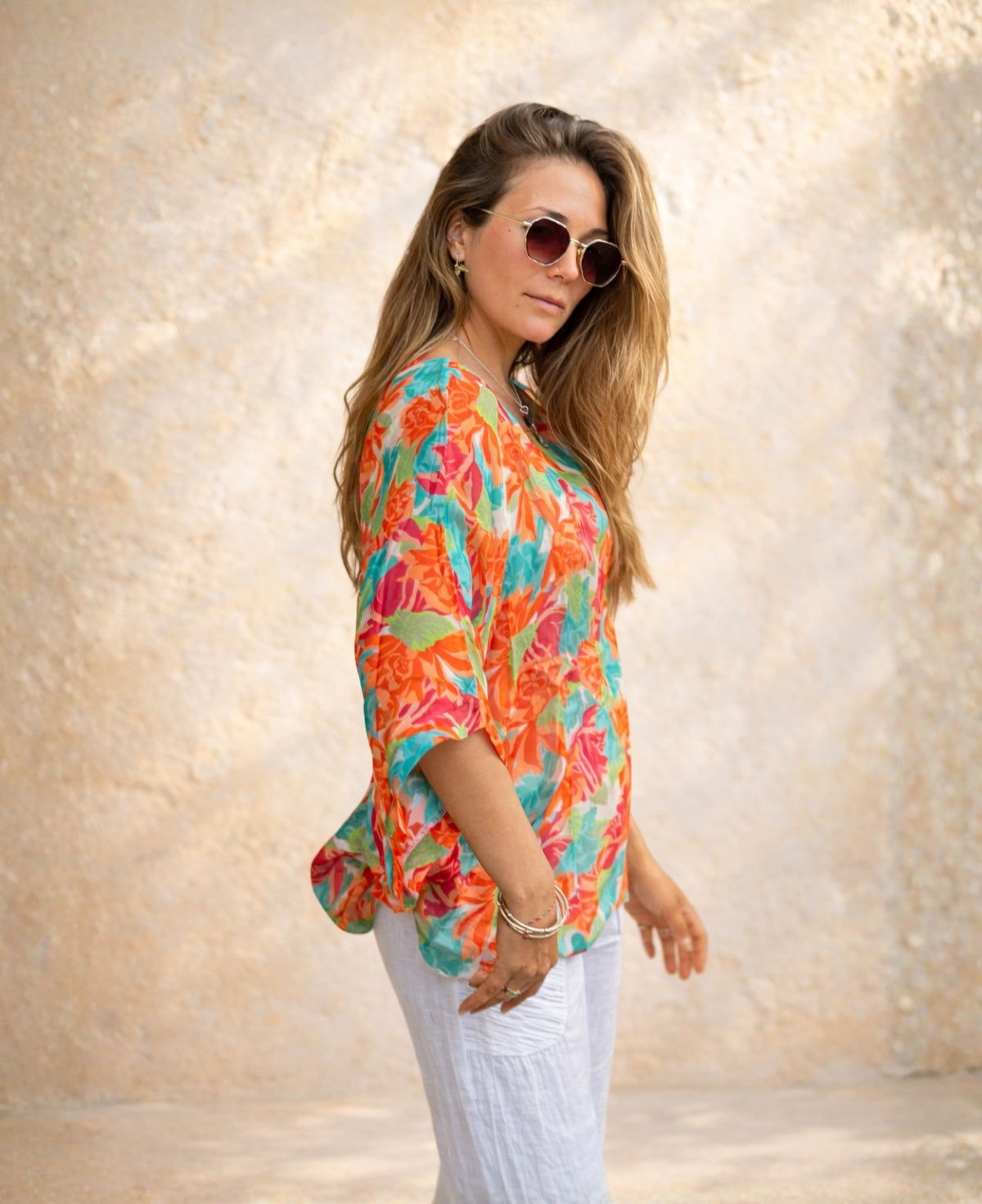 Side view of the Roses Silk Top in rose floral print showing the relaxed drape and batwing sleeve fit.