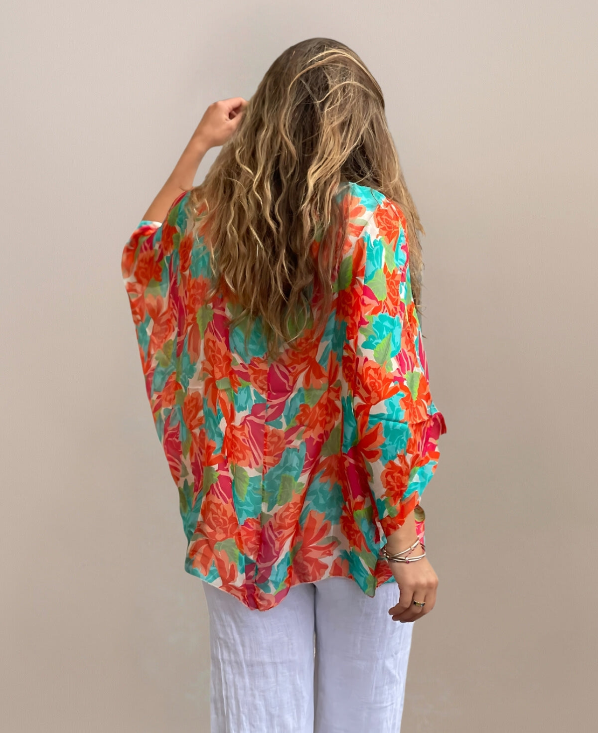 Back view of Roses Silk Top showcasing vibrant floral print and relaxed fit