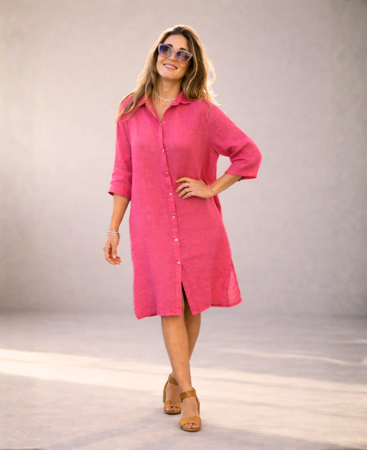 Strawberry Samira Linen Shirt-Dress in soft studio light, styled as a dress with hand on hip, showing natural linen texture and easy silhouette.