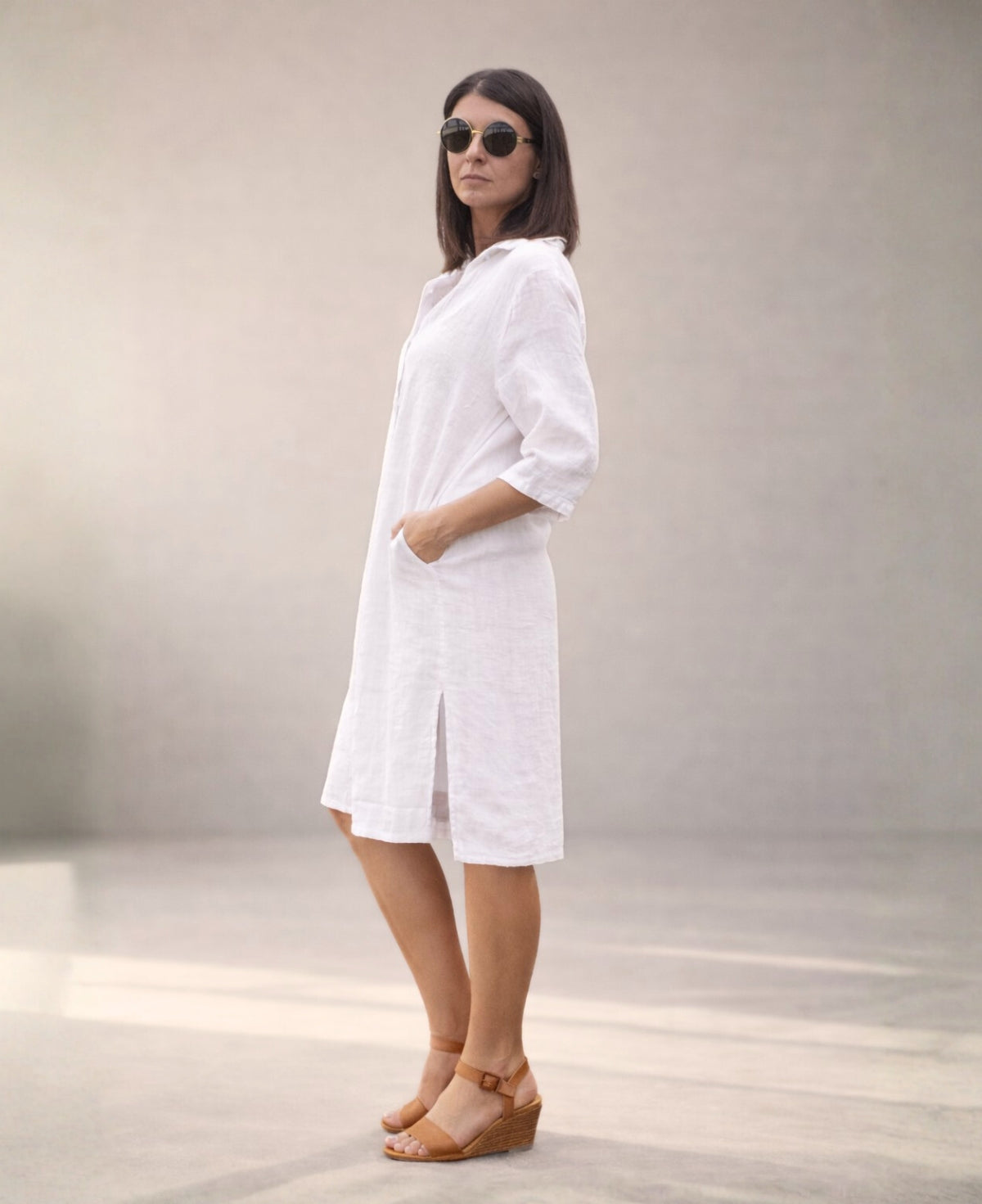 White Samira Linen Shirt-Dress side studio view showcasing discreet side seam pockets and relaxed linen structure.
