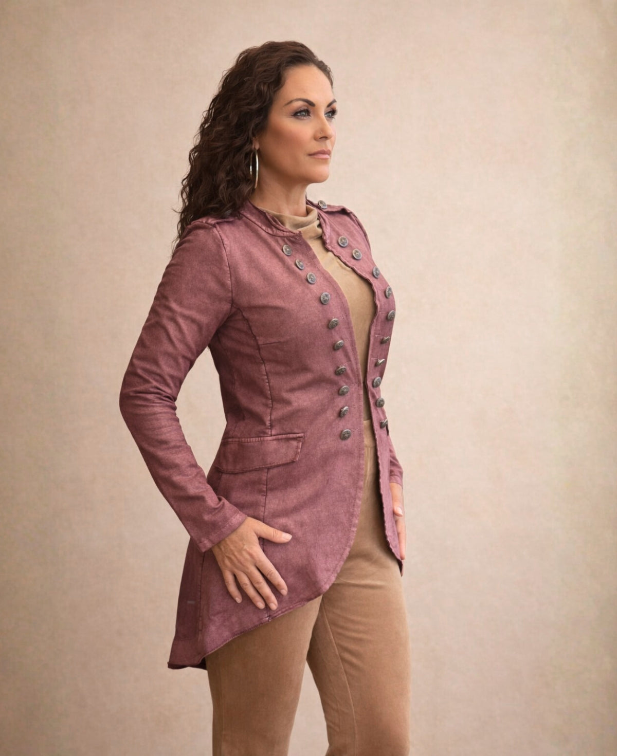 Side view of the Sergeant Pepper Jacket in wine showing the fitted bodice, flared hem and stretch waxed cotton fabric.