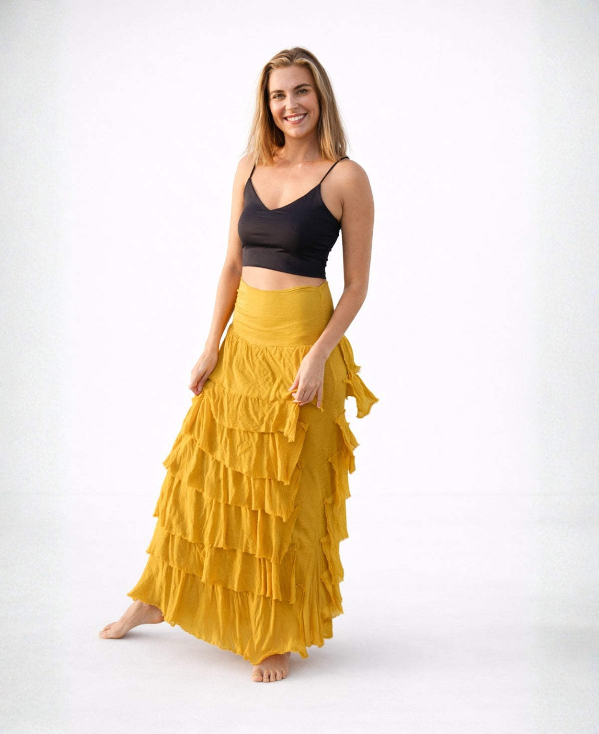 Woman wearing Dijon Silk Blend Feather Skirt Dress in soft mustard tone highlighting flowing layered design and relaxed fit