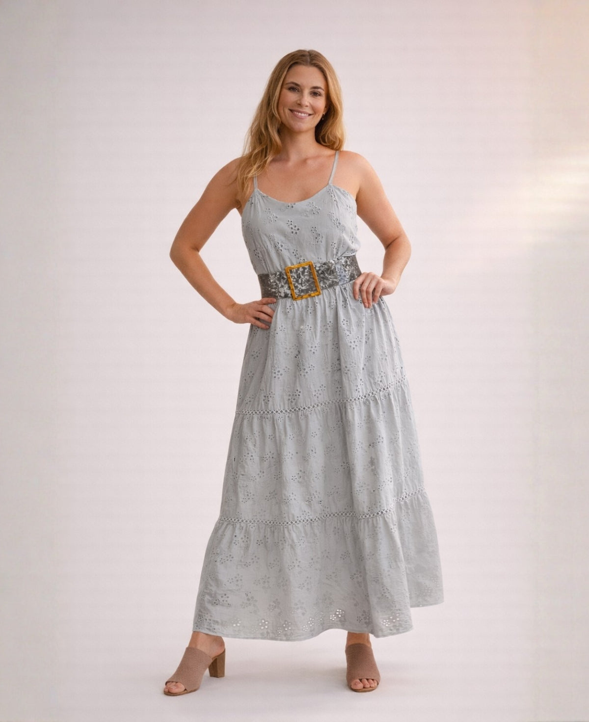 Front view of the Skylar Cotton Eyelet Dress in silver grey styled with a wide statement belt, featuring cotton eyelet embroidery and a tiered maxi skirt