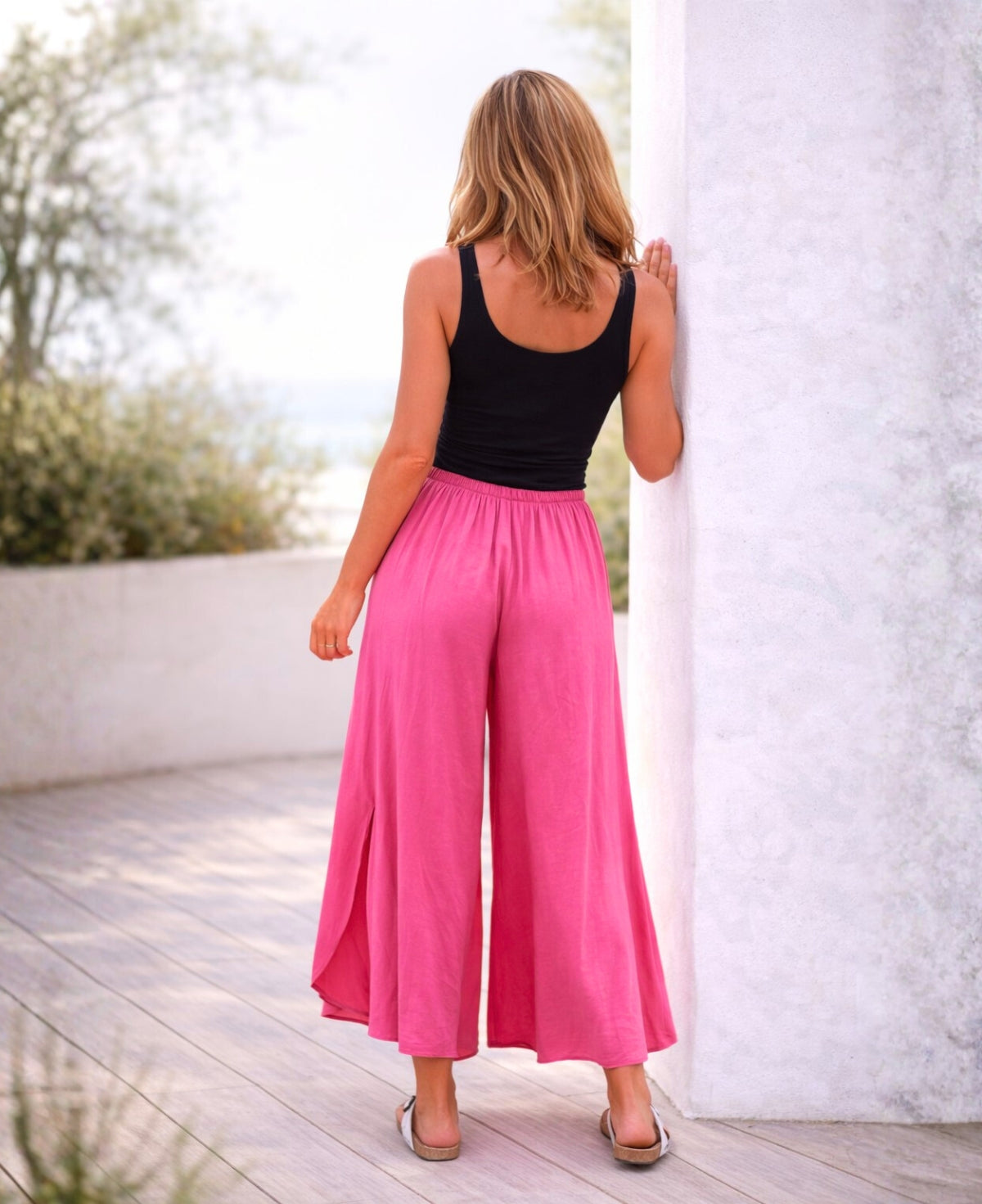 Back view of pink Somma rayon wide leg pants with fluid movement and relaxed silhouette