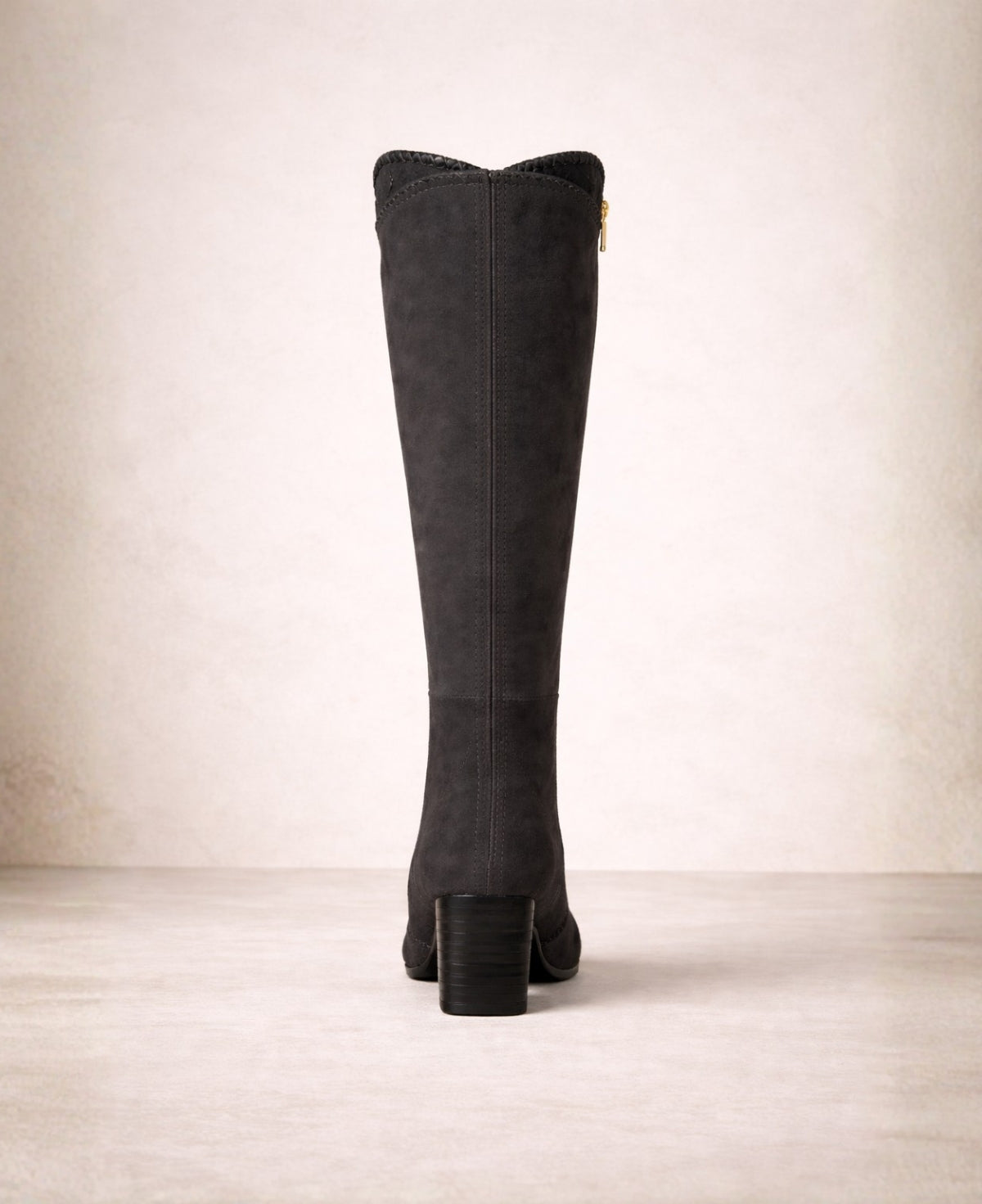 Back view of black suede knee high boots showing swept top edge, centre back seam and stacked block heel