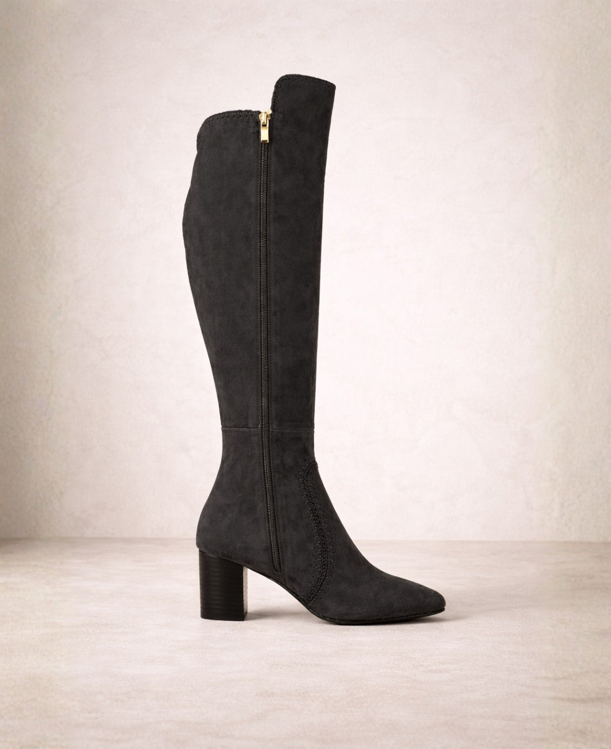 Black suede knee high boots featuring inner side zip, whipstitch detailing and elegant pointed toe