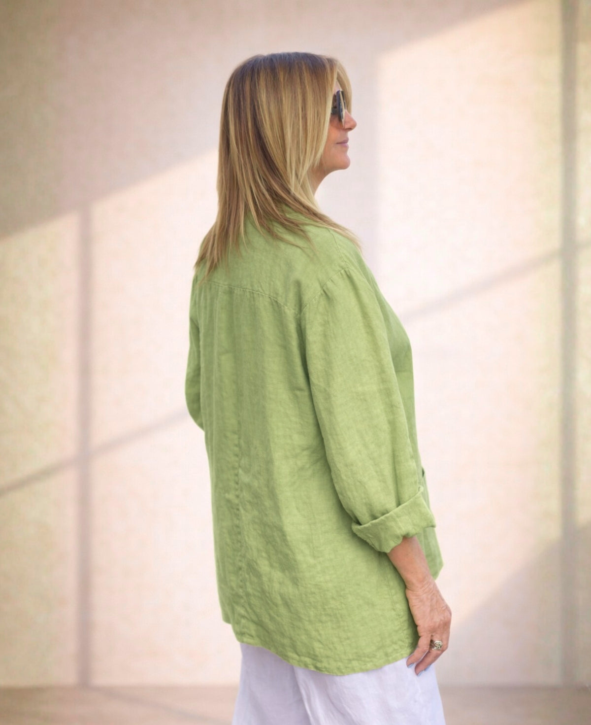 Leaf green linen blazer featuring a lightweight, breathable fabric, tailored fit, and double-button closure for a polished yet relaxed style