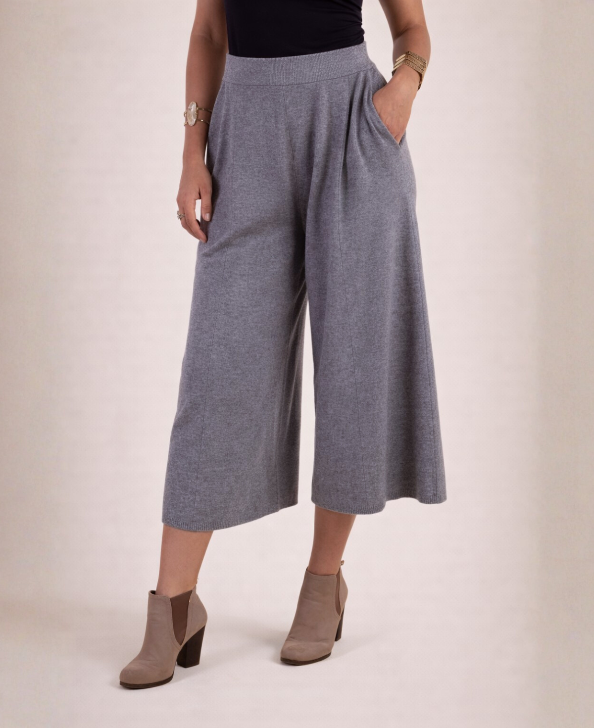 Front detail of cool grey Winter Knit Culottes with one hand in pocket and ankle boots, highlighting the knit texture and pleats.