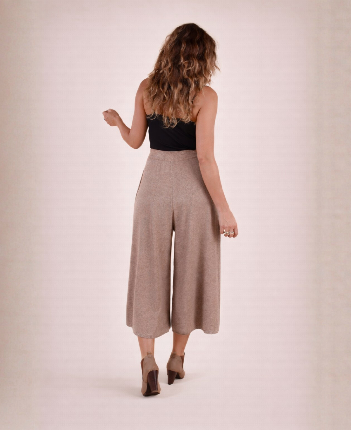 Back view of mocka Winter Knit Culottes styled with a black tank top and ankle boots.