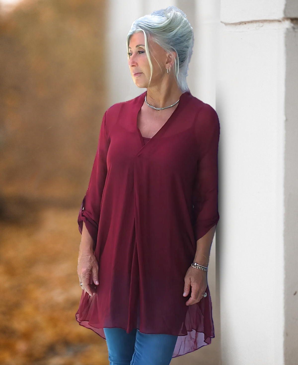 April long silk top in wine colour worn as a longline tunic with relaxed drape in a soft outdoor setting