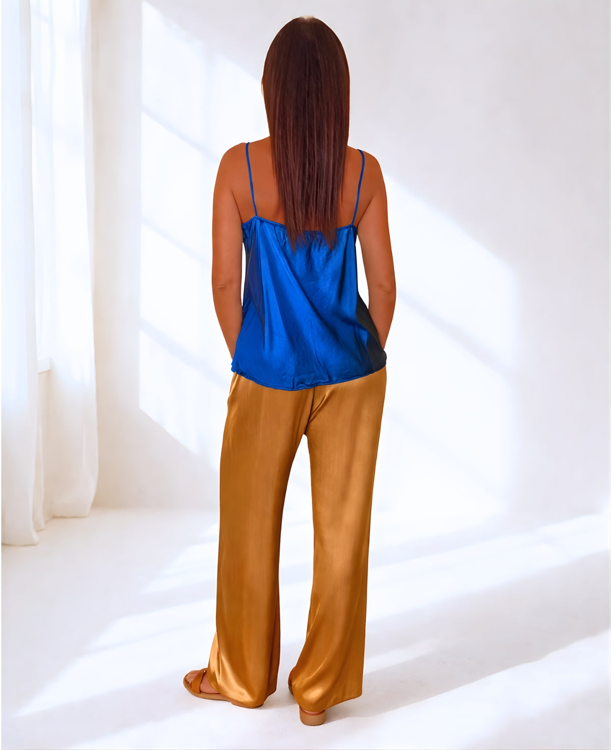 Electric blue satin camisole back view with smooth drape and delicate straps