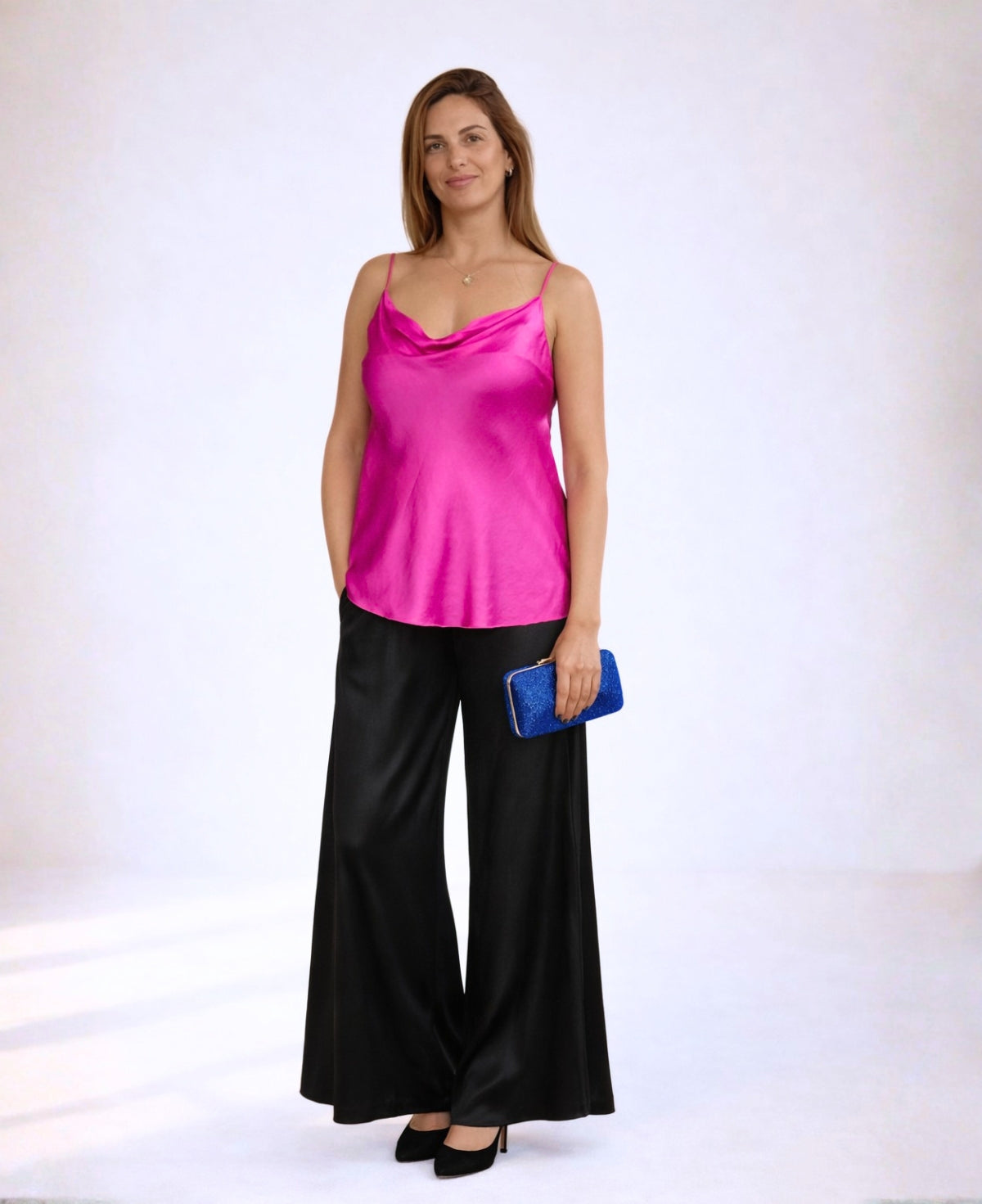 Hot pink satin camisole styled with black satin wide leg pants and evening clutch
