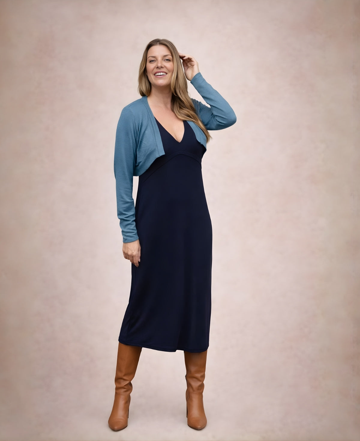 Blue teal Nell bolero styled with navy dress and boots full body angled view