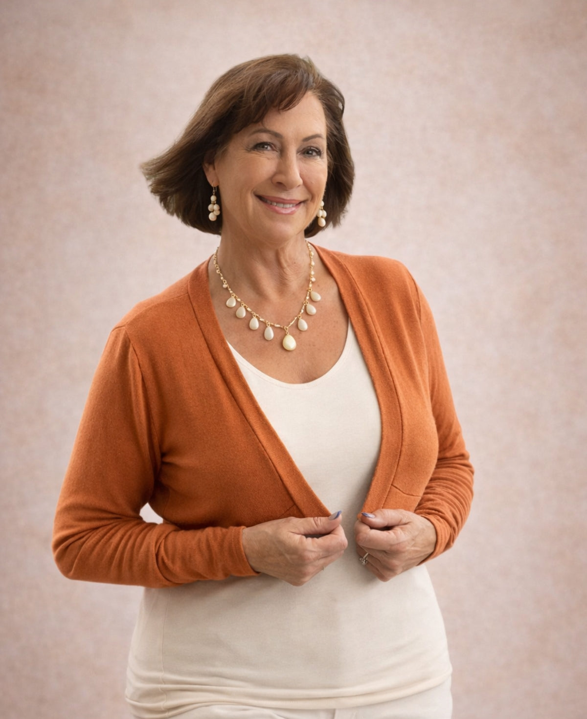Rust Nell bolero front view styled with warm ivory top cropped long sleeve bolero
