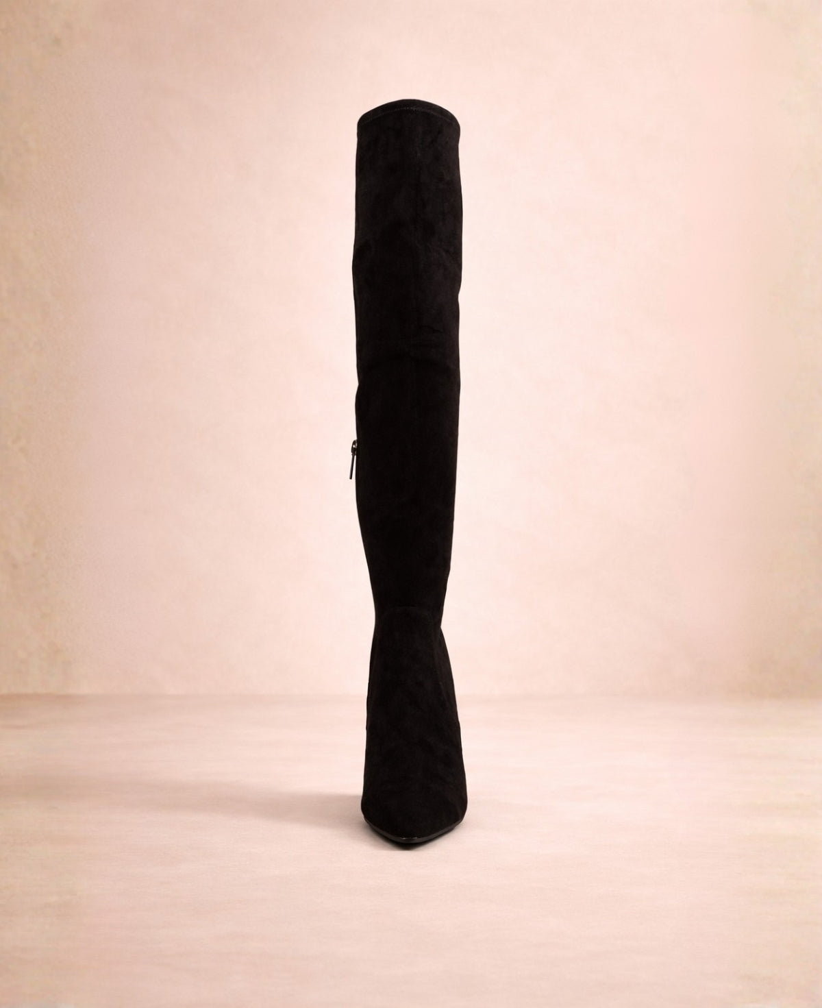 Front view of black above-the-knee boots highlighting the pointed toe and clean, streamlined silhouette.
