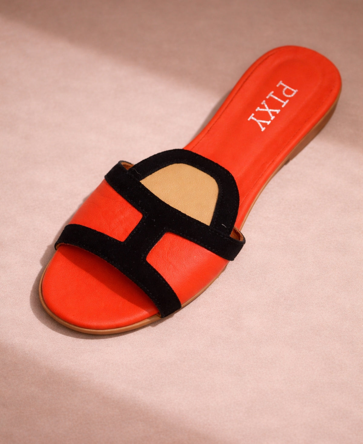 Top view of PIXY slide sandal showing colour block strap and coral leather footbed with logo