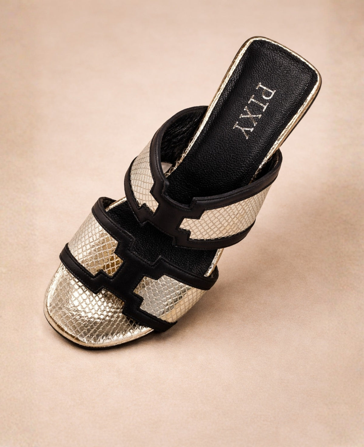 Top view of PIXY metallic gold snakeskin slide sandals for women showing snakeskin texture and black leather edging
