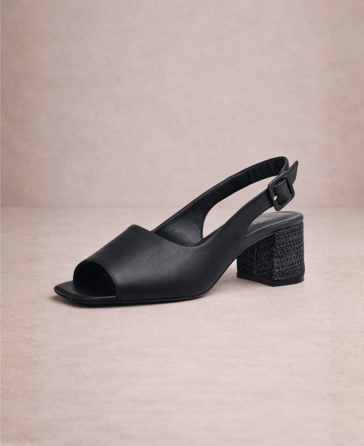 Black leather slingback heel with open square toe and soft upper, angled front view