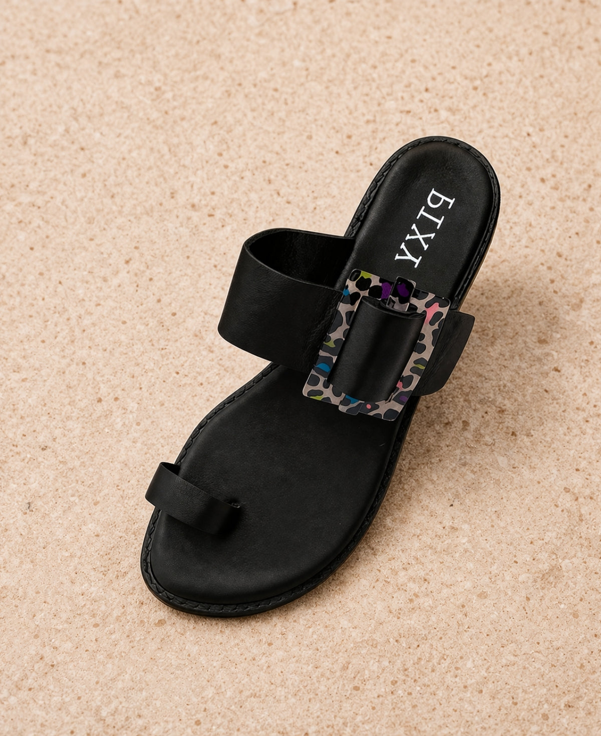Top view of black PIXY Shebah Slide sandal highlighting toe loop and buckle strap design