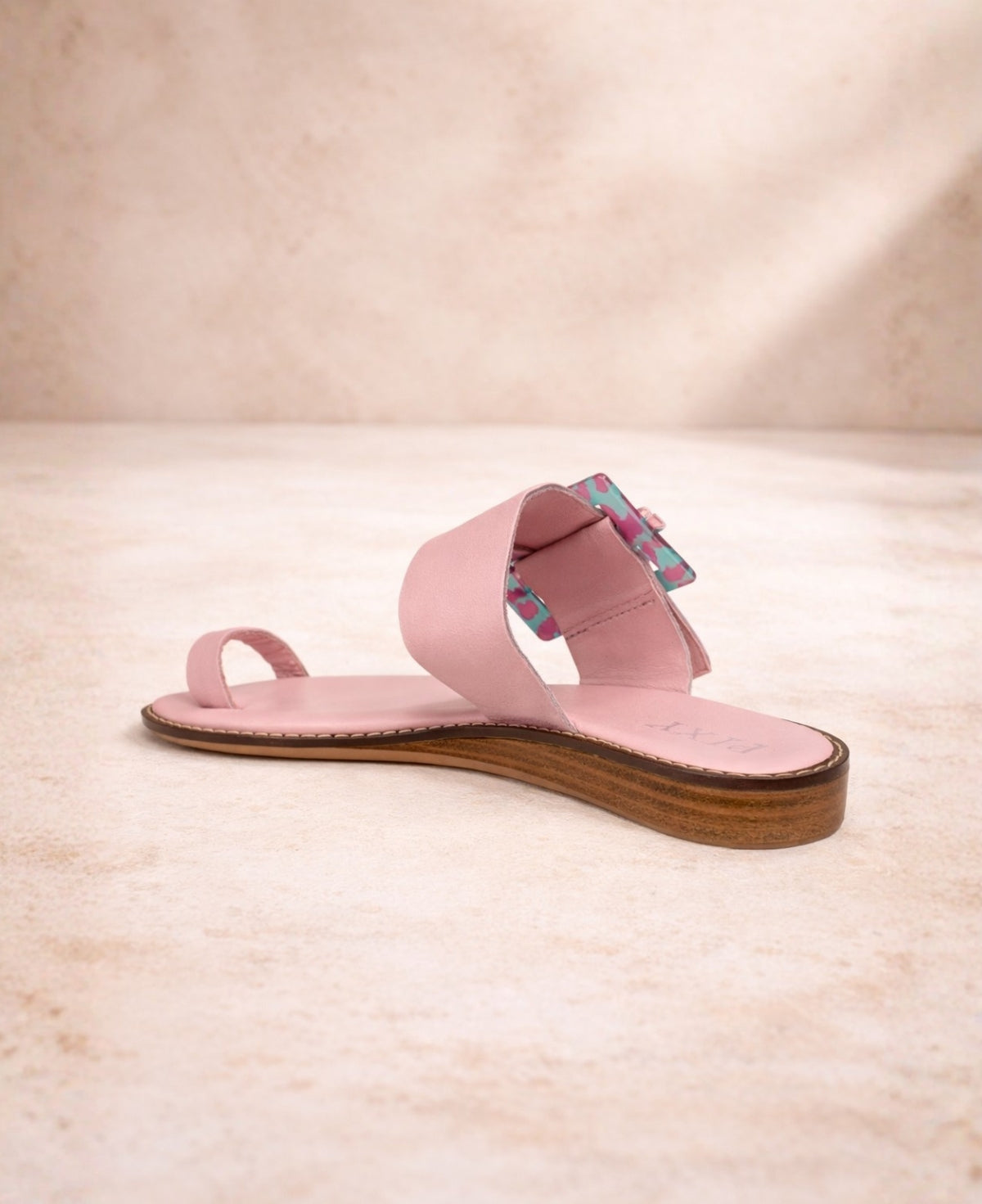 Pink leather sandal back angled view showing strap structure and sole