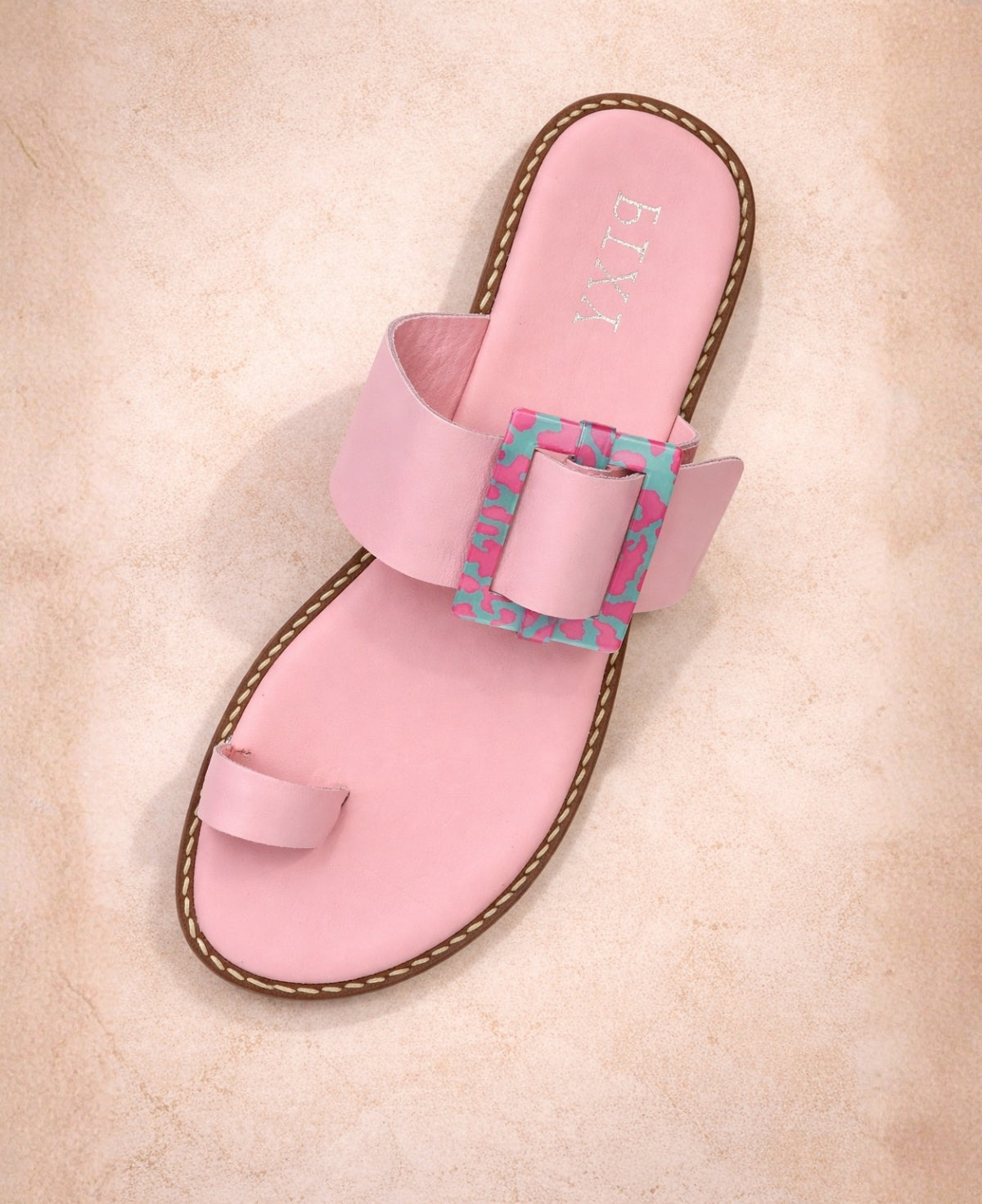 Pink leather buckle slide sandal top view showing toe loop and wide strap