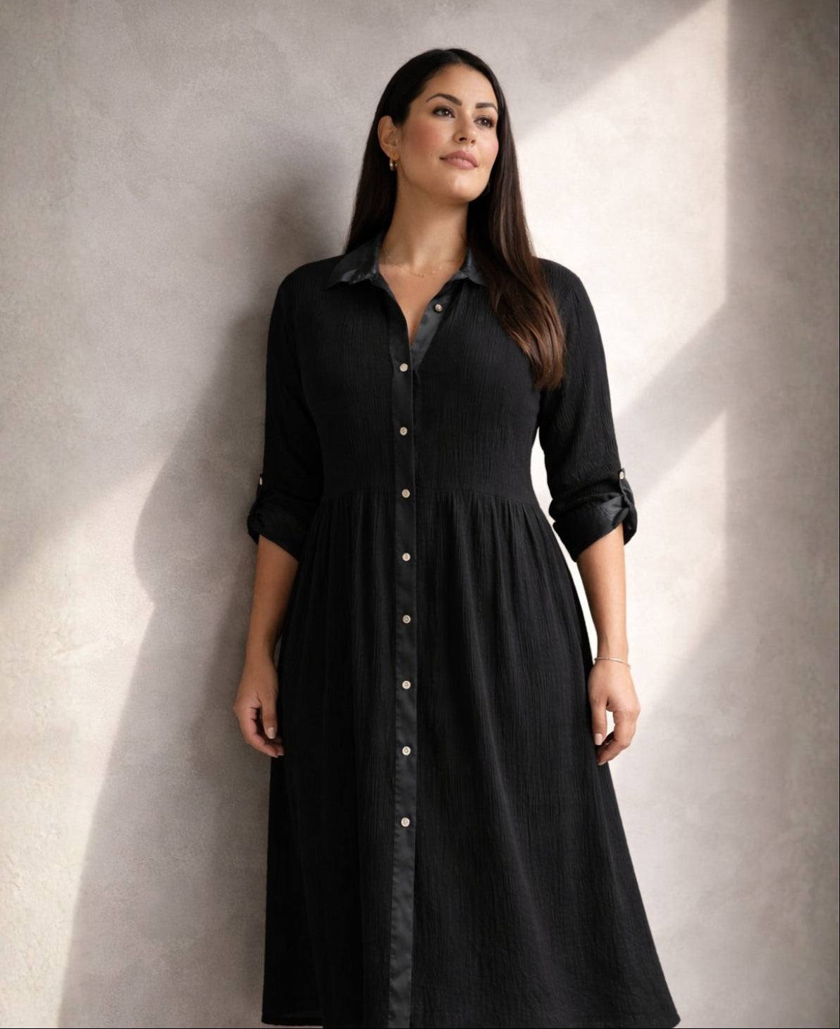 Black Roxberry Curvy Fit shirt dress in directional light highlighting satin collar, satin placket and vertical crinkle texture with sculpted silhouette.