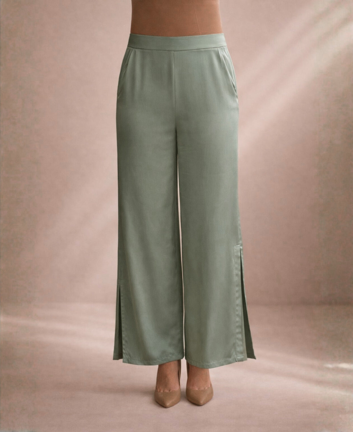 Sage satin wide leg pants front view with flat waistband and fluid wide leg silhouette