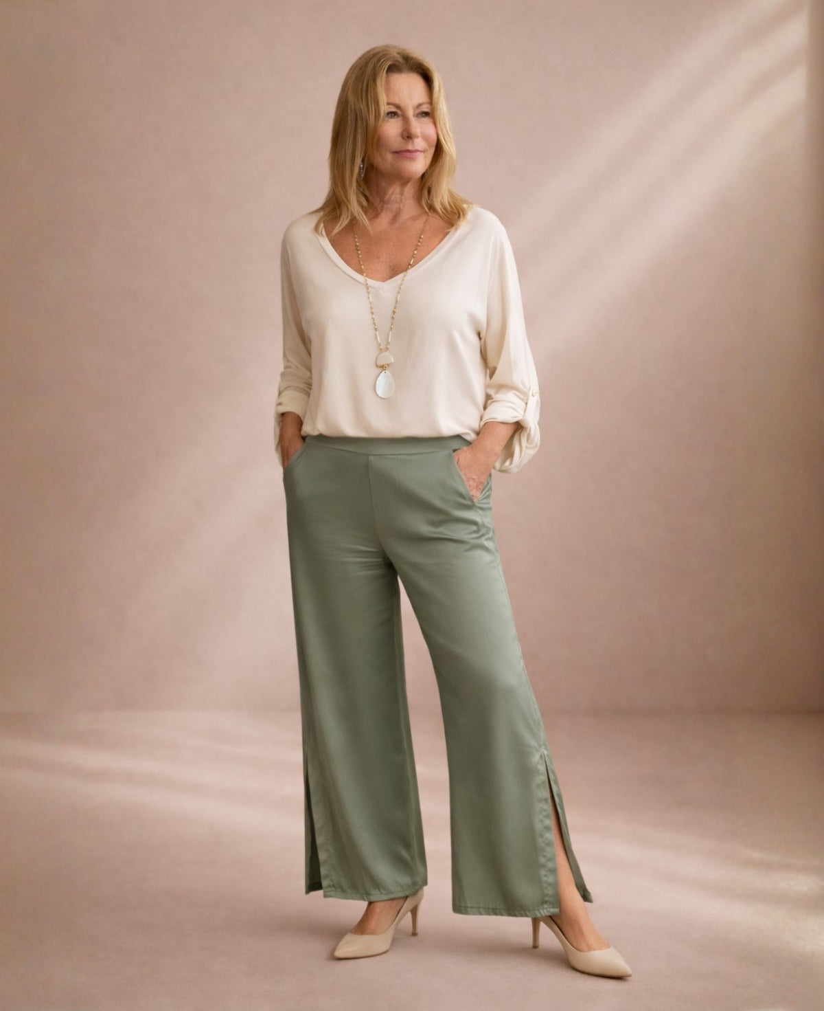Sage satin wide leg pants styled with soft blouse showing relaxed fit and side split